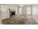 Spacious living room with a brick fireplace, carpet, and plenty of natural light at 5073 Leland Dr, Stone Mountain, GA 30083