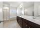 Bright bathroom with double vanity, large mirrors, and separate shower and tub at 7644 Rudder Cir, Fairburn, GA 30213