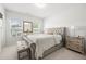 Bedroom boasts natural light with a tufted headboard and a gray bench at the foot of the bed at 7644 Rudder Cir, Fairburn, GA 30213