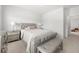 Well-lit bedroom with neutral color scheme, tufted headboard, and coordinating bench at 7644 Rudder Cir, Fairburn, GA 30213