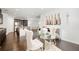 Open concept dining area with stainless steel appliances, dark cabinets, hardwood floors, and modern decor at 7644 Rudder Cir, Fairburn, GA 30213