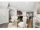Open dining area with modern decor, dark hardwood floors, and decorative lighting adjacent to kitchen at 7644 Rudder Cir, Fairburn, GA 30213