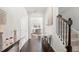 Bright foyer with dark wood floors, white trim, staircase, mirror console table, and decorative lighting at 7644 Rudder Cir, Fairburn, GA 30213