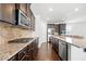 Well-equipped kitchen featuring dark cabinets, stainless steel appliances, and granite countertops at 7644 Rudder Cir, Fairburn, GA 30213