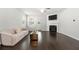 Bright living room with hardwood floors, a fireplace, modern lighting, and a patio walkout at 7644 Rudder Cir, Fairburn, GA 30213