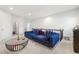 Second floor living room with blue sectional, and stylish coffee table at 7644 Rudder Cir, Fairburn, GA 30213