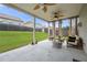Covered patio with ceiling fans and stylish seating provides a perfect space for outdoor relaxation at 7644 Rudder Cir, Fairburn, GA 30213