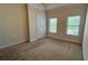 Bedroom with carpet flooring, ceiling fan, and natural light from two windows at 793 Inman Mews Ne Dr, Atlanta, GA 30307
