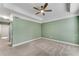 A bright bedroom features neutral carpet, green walls, a white ceiling, and an overhead light at 793 Inman Mews Ne Dr, Atlanta, GA 30307