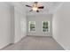 Bright bedroom with neutral carpet, white walls, a tray ceiling with fan, and natural light from two windows at 793 Inman Mews Ne Dr, Atlanta, GA 30307