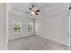 Bright bedroom with neutral carpet, white walls, a tray ceiling with fan, and natural light from two windows at 793 Inman Mews Ne Dr, Atlanta, GA 30307