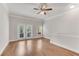 Bright room featuring wood floors, ceiling fan, and a private balcony entrance at 793 Inman Mews Ne Dr, Atlanta, GA 30307