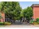 Gated community entrance with mature trees, iron fence, and colorful landscaping at 793 Inman Mews Ne Dr, Atlanta, GA 30307