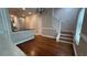 Open-concept entryway with hardwood floors and staircase with white railings at 793 Inman Mews Ne Dr, Atlanta, GA 30307