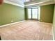 Spacious primary bedroom with bay window, tray ceiling, and plush carpeting at 793 Inman Mews Ne Dr, Atlanta, GA 30307