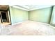 Spacious primary bedroom with tray ceiling, plush carpeting, and neutral walls at 793 Inman Mews Ne Dr, Atlanta, GA 30307