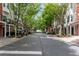 Tree-lined street view in a charming townhome community with manicured landscaping at 793 Inman Mews Ne Dr, Atlanta, GA 30307