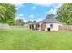 Spacious backyard featuring a covered patio, lush lawn, storage shed, and fenced perimeter at 15 Echota Ne Rd, Cartersville, GA 30121