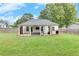 Well maintained backyard offering lush green grass, a covered patio, and fenced perimeter for privacy at 15 Echota Ne Rd, Cartersville, GA 30121