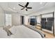 Bright bedroom featuring a ceiling fan, an ensuite bathroom, and wire shelving for organized storage at 15 Echota Ne Rd, Cartersville, GA 30121