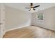 Neutral bedroom showcasing wood floors, a ceiling fan, and a window providing natural light at 15 Echota Ne Rd, Cartersville, GA 30121