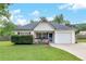 Charming single-story home featuring a well-manicured lawn and an attached one car garage at 15 Echota Ne Rd, Cartersville, GA 30121