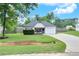 A charming one-story home with a lovely front yard and a driveway leading to an attached garage at 15 Echota Ne Rd, Cartersville, GA 30121