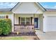 Inviting front porch with seating area, dark wood trim and a lovely view of the yard at 15 Echota Ne Rd, Cartersville, GA 30121