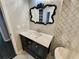 Elegant bathroom featuring a modern vanity with a striking black-framed ornate mirror at 220 Renaissance Ne Pkwy # 2220, Atlanta, GA 30308