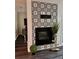 Stylish fireplace with decorative tile and adjacent seating area in living room at 220 Renaissance Ne Pkwy # 2220, Atlanta, GA 30308