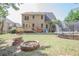 Exterior backyard of home featuring a wooden deck, hot tub, fire pit and trampoline at 25 Nunnally Pl, Villa Rica, GA 30180