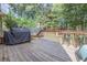 Wooden deck featuring a grill and dining area, perfect for entertaining at 25 Nunnally Pl, Villa Rica, GA 30180