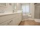 Well lit bathroom features a tub and shower, bright natural light, and a single vanity sink at 25 Nunnally Pl, Villa Rica, GA 30180