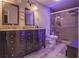 Modern bathroom with a double vanity, framed mirrors, a glass shower, and luxury vinyl floors at 25 Nunnally Pl, Villa Rica, GA 30180