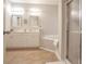 Bathroom features a double vanity, tile flooring, and a shower with glass doors at 25 Nunnally Pl, Villa Rica, GA 30180