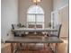 Elegant dining room with ample natural light, stylish bench seating, and hardwood floors, perfect for entertaining at 25 Nunnally Pl, Villa Rica, GA 30180