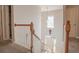 Foyer staircase with wood railings and a view of the front door at 25 Nunnally Pl, Villa Rica, GA 30180