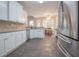 Bright kitchen with stainless steel appliances, white cabinetry, and eat-in area, ideal for cooking and dining at 25 Nunnally Pl, Villa Rica, GA 30180