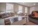 Bright living room with a large couch, modern coffee table, and plenty of natural light at 25 Nunnally Pl, Villa Rica, GA 30180