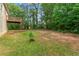 Large backyard with trees, lush greenery, and a wooden deck for outdoor activities at 5960 Castlegate Dr, Douglasville, GA 30135