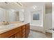 Bathroom featuring double sinks, wooden cabinets, a soaking tub and a stand up shower at 5960 Castlegate Dr, Douglasville, GA 30135