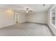 Bright and spacious bedroom with neutral carpet, ceiling fan, and arched entry for flexible design at 5960 Castlegate Dr, Douglasville, GA 30135