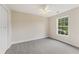 Comfortable bedroom with neutral carpeting, bright window, and closet for storage at 5960 Castlegate Dr, Douglasville, GA 30135