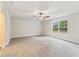 Expansive bedroom featuring neutral carpeting, a ceiling fan, and natural light from a large window at 5960 Castlegate Dr, Douglasville, GA 30135