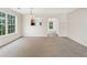Open dining area with carpet, bright light from the windows, and easy access to kitchen space at 5960 Castlegate Dr, Douglasville, GA 30135