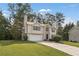 The exterior view showcases the home's manicured lawn and traditional architecture at 5960 Castlegate Dr, Douglasville, GA 30135