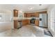 Modern kitchen with stainless steel appliances, wooden cabinetry, and easy access to the living area, perfect for cooking at 5960 Castlegate Dr, Douglasville, GA 30135