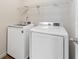 Laundry room with new, white washer and dryer units ready to accommodate all your laundry needs at 5960 Castlegate Dr, Douglasville, GA 30135
