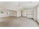 Bright living room featuring plush carpet, a ceiling fan, and natural light from large windows, great for entertaining at 5960 Castlegate Dr, Douglasville, GA 30135