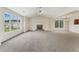 Spacious living room featuring a fireplace, ceiling fan, and large windows that provide ample natural light at 5960 Castlegate Dr, Douglasville, GA 30135